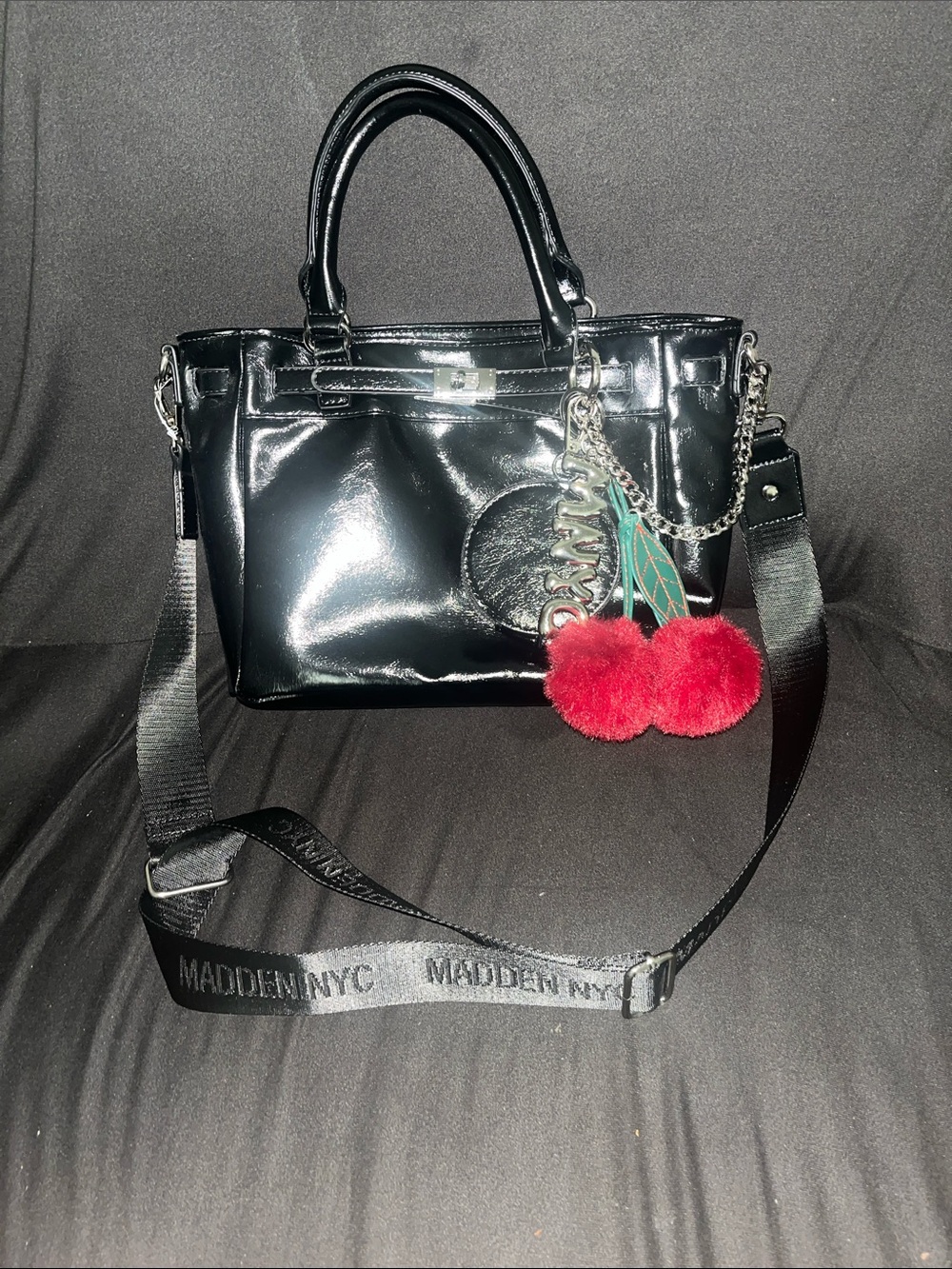 Madden NYC Black Patent Satchel with Red Pom Charm